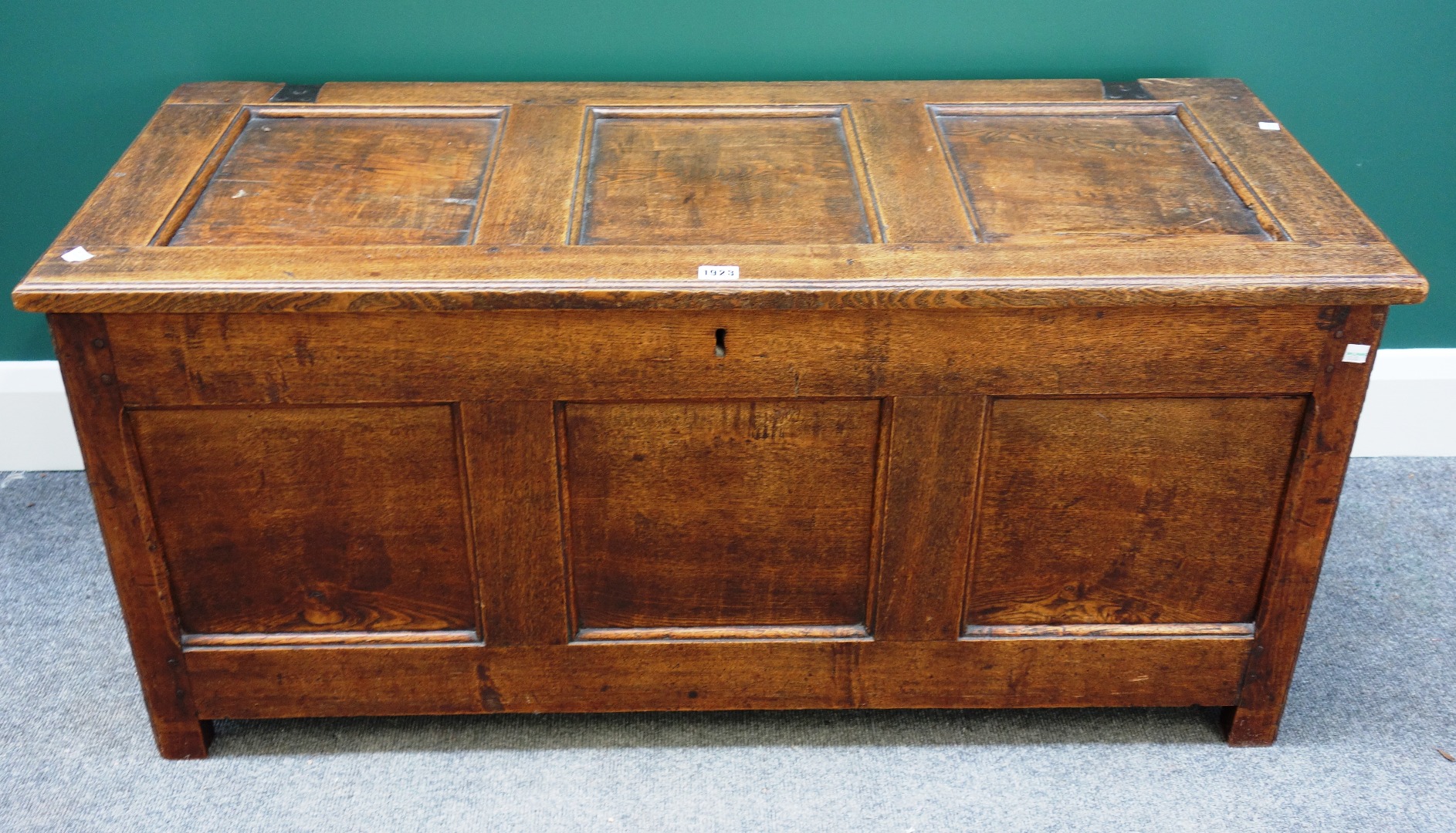 Appraisal: An early th century oak coffer with triple panelled lid