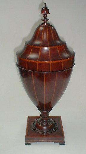 Appraisal: A Sheraton style string inlaid flamed mahogany urn and cover