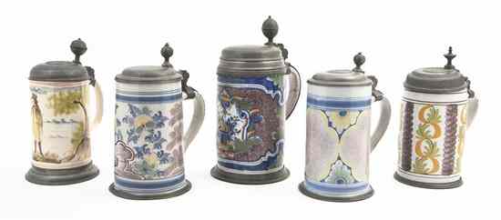 Appraisal: A Collection of Five Pewter Mounted Faience Steins of varying