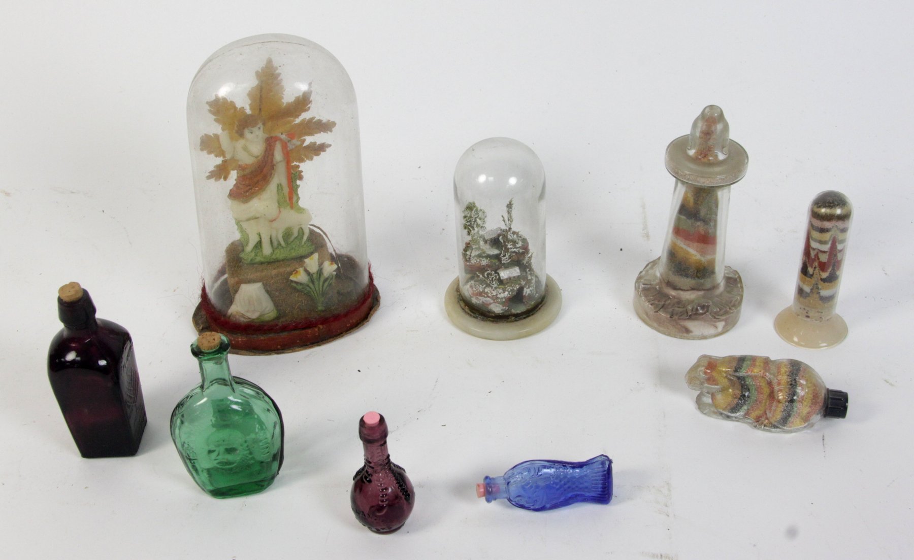 Appraisal: Two miniature dioramas under glass domes four potion bottles and