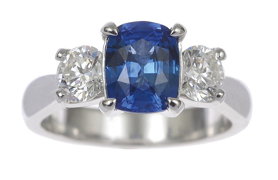 Appraisal: A SAPPHIRE AND DIAMOND THREE STONE RING Centrally set with