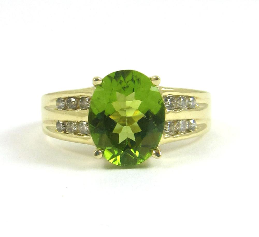 Appraisal: PERIDOT DIAMOND AND FOURTEEN KARAT GOLD RING with two rows