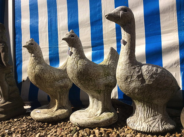 Appraisal: TWO COMPOSITE STONE CHICKENS each cm in height a composite