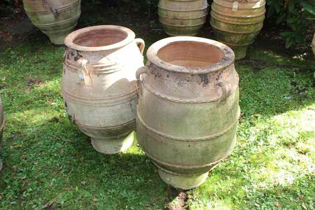 Appraisal: TWO SIMILAR TERRACOTTA PLANTERS of ovoid form with ribbed decoration