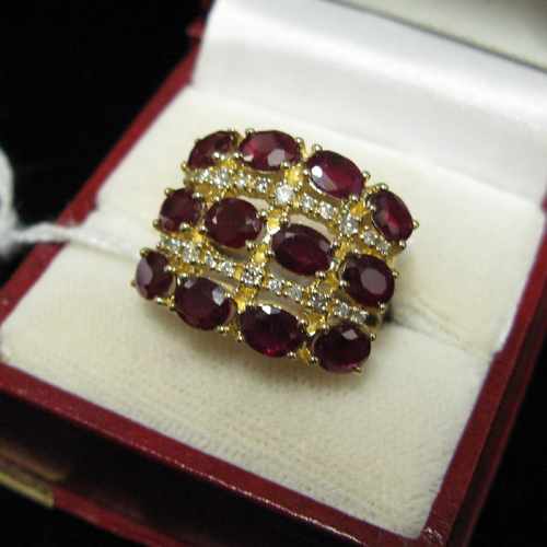 Appraisal: RUBY DIAMOND AND FOURTEEN KARAT GOLD RING having three rows