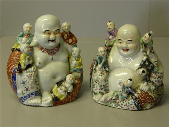 Appraisal: Pair of Chinese porcelain buddhas with children playing on them