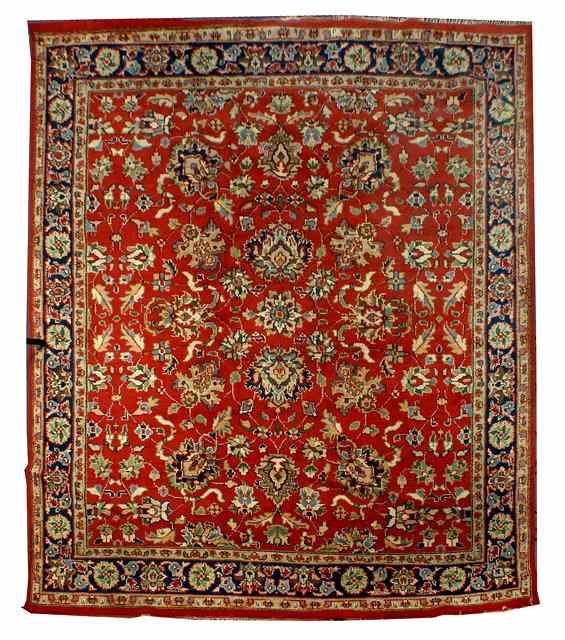 Appraisal: AN INDIAN RED GROUND CARPET with a continuing pattern of