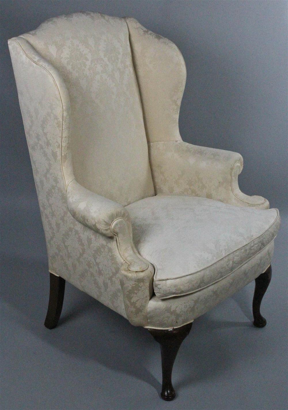 Appraisal: QUEEN ANNE STYLE UPHOLSTERED WING CHAIR the shaped crest and