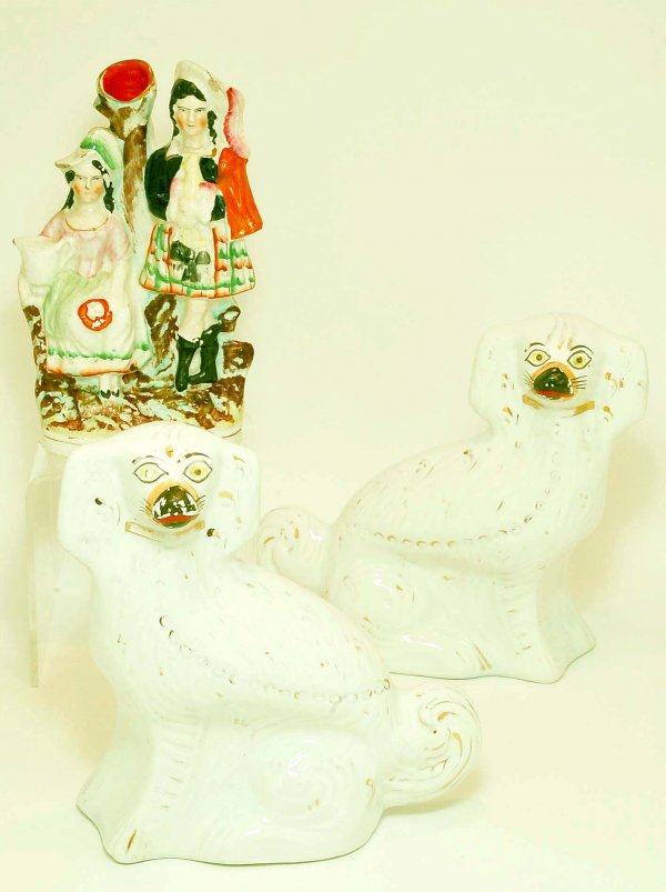 Appraisal: A pair of Staffordshire spaniels White curly tailed seated spaniels