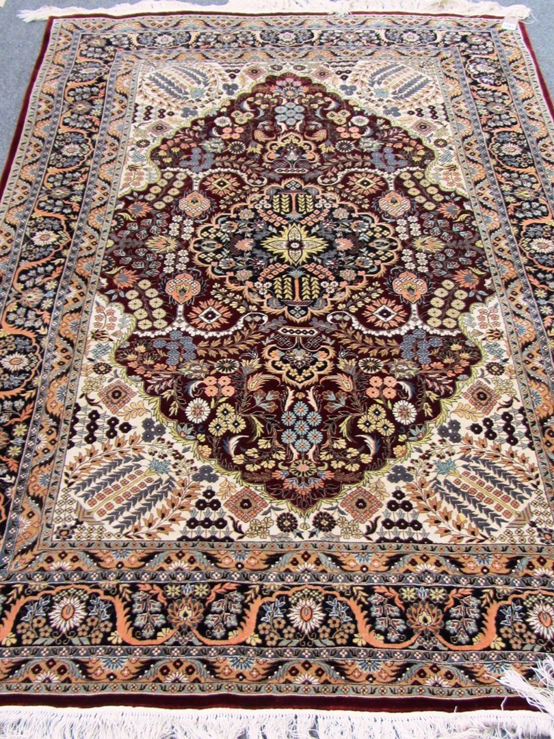 Appraisal: A fine silk Hereke rug Turkish the madder field with