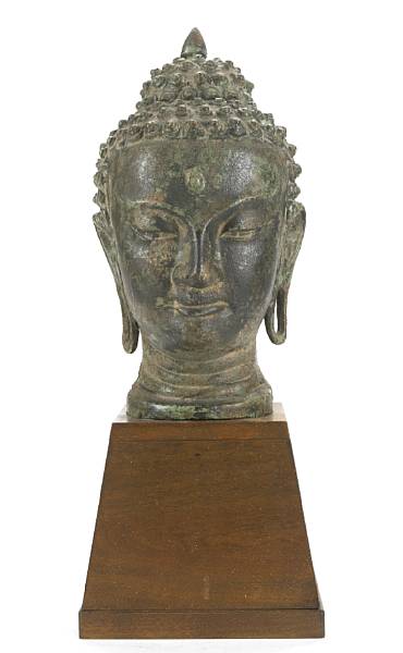 Appraisal: A Thai style patinated metal head of Buddha on stand