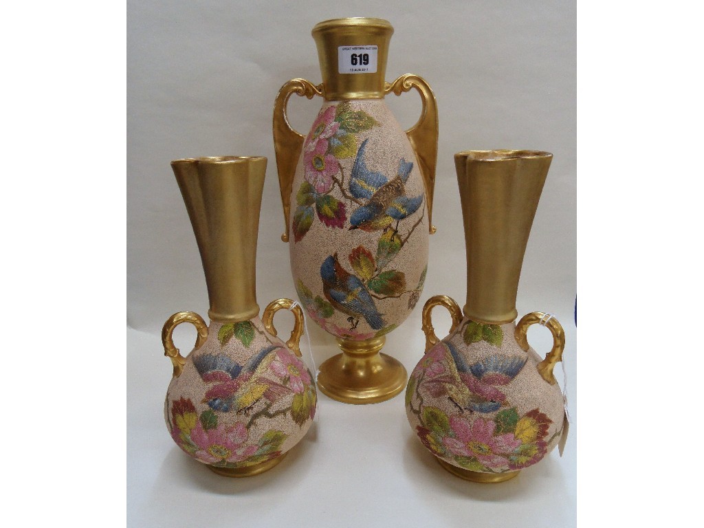 Appraisal: Continental pottery garniture each piece decorated with birds on flowering