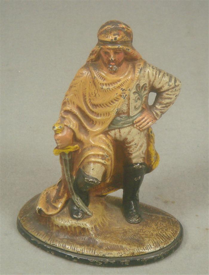 Appraisal: Cast iron doorstop desert warrior with sword on tan base