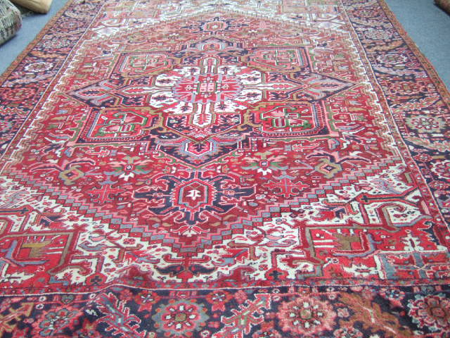 Appraisal: A Heriz carpet the madder field with a bold central