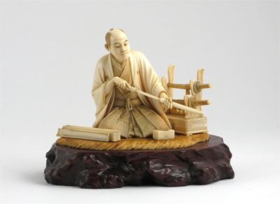 Appraisal: A Japanese ivory carving of a man kneeling on a