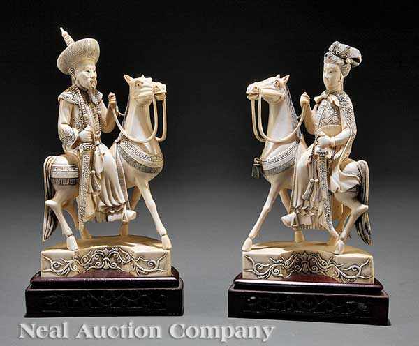 Appraisal: A Pair of Chinese Ivory Emperor and Empress Figures Astride