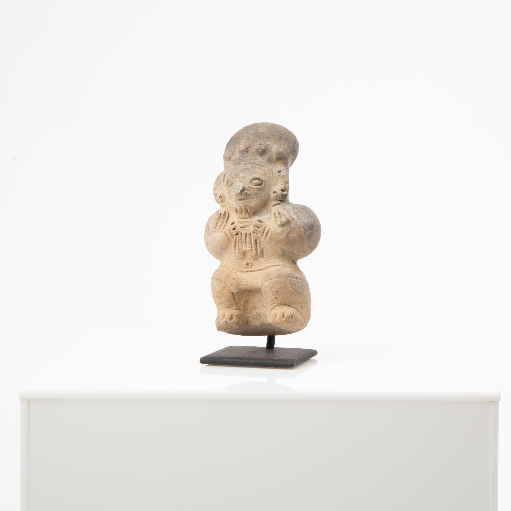 Appraisal: A PRE-COLUMBIAN DEITY EFFIGY FIGURE DEVOURING CHILD A pre-Columbian South