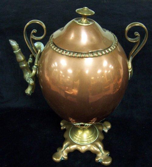 Appraisal: An oval copper two-handled tea urn and cover the base