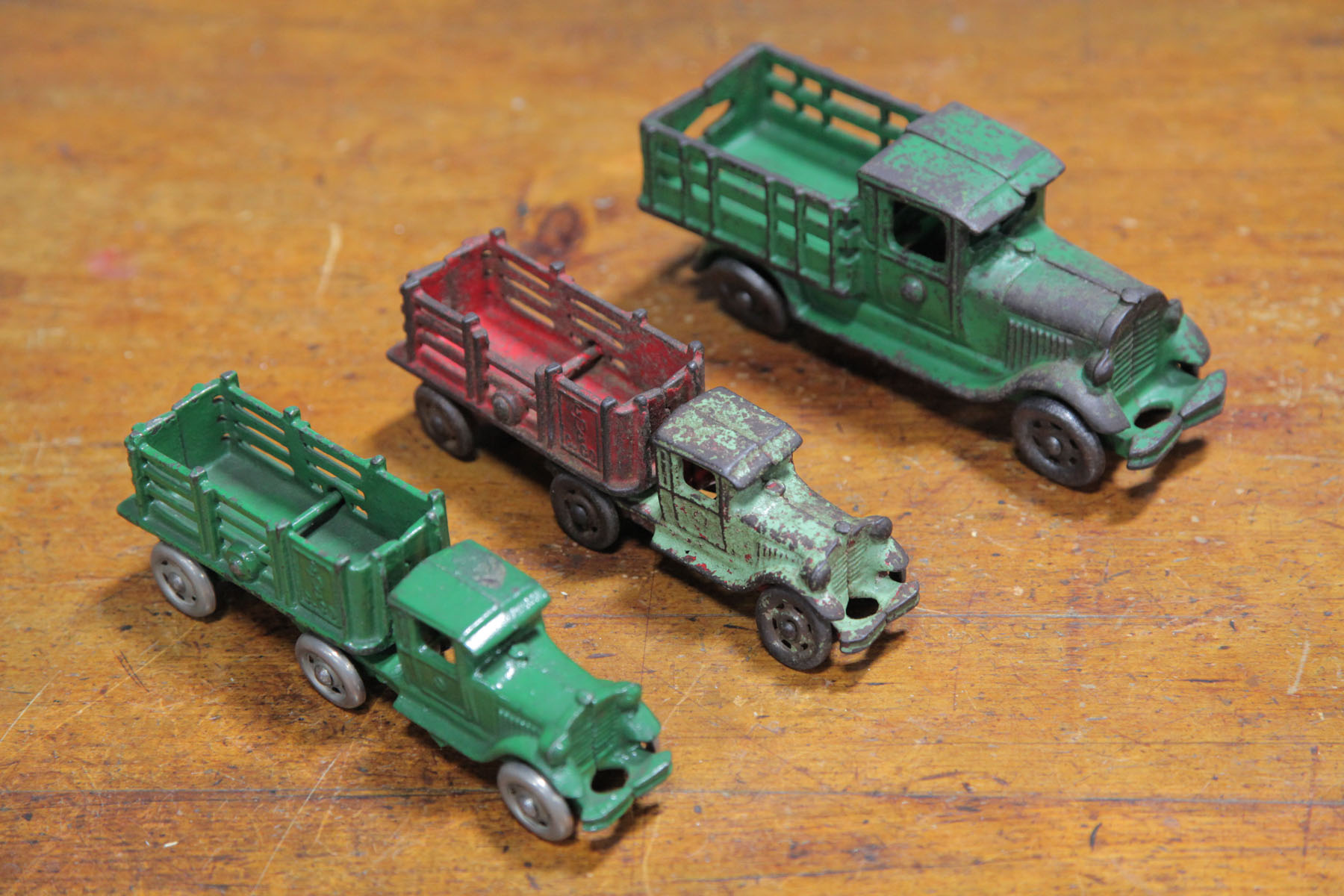 Appraisal: THREE CAST IRON TRUCKS American early th century Two Coast