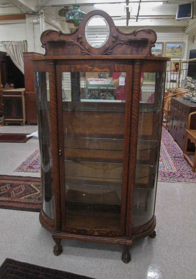 Appraisal: AN OAK AND CURVED GLASS CHINA CABINET Larkin Co aka