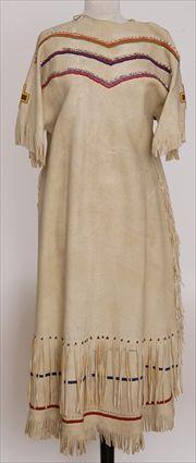 Appraisal: NORTHERN PLAINS BUCKSKIN WOMAN'S DRESS With multi-colored beads and cowrie