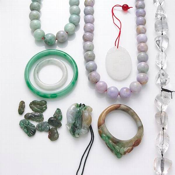 Appraisal: A miscellaneous collection of multi-colored jade items including strands of