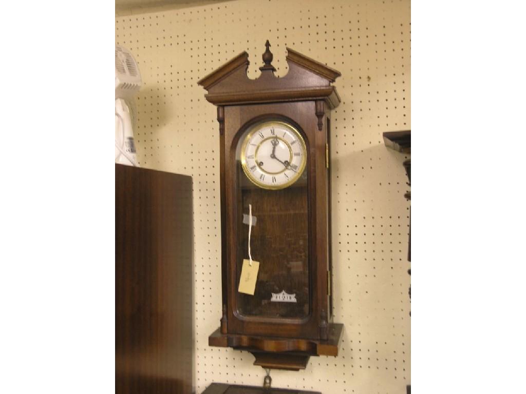 Appraisal: A German wall clock with enamelled dial and gong-striking movement