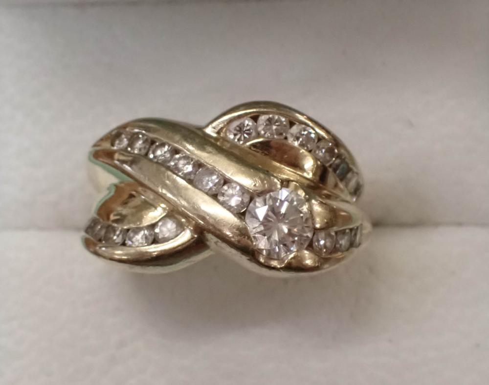 Appraisal: DIAMOND AND FOURTEEN KARAT YELLOW GOLD RING with round full-cut