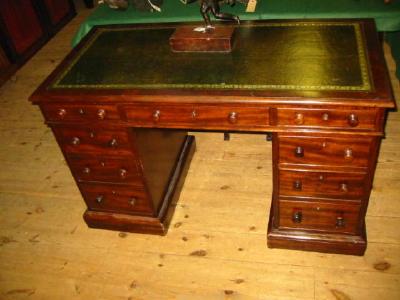 Appraisal: A VICTORIAN MAHOGANY PEDESTAL DESK with green leather lined top