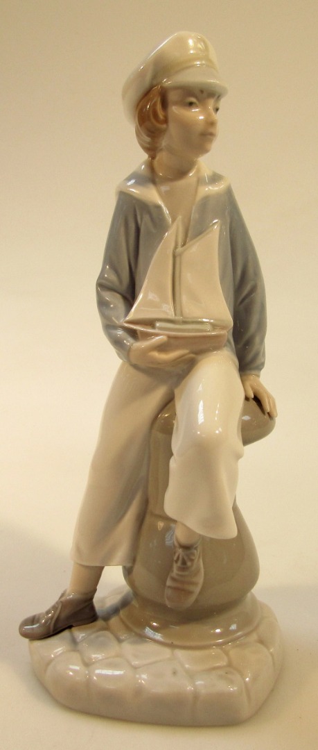 Appraisal: A thC Lladro figure of a sailor boy sat in