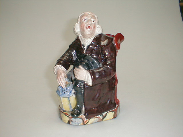 Appraisal: A Victorian Staffordshire Toby Jug of seated preacher with lantern