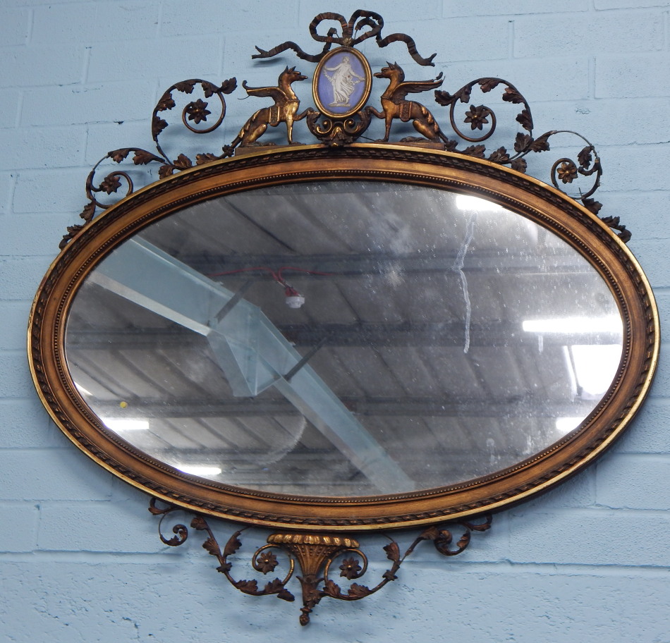 Appraisal: A thC gilt gesso wall mirror the crest applied with