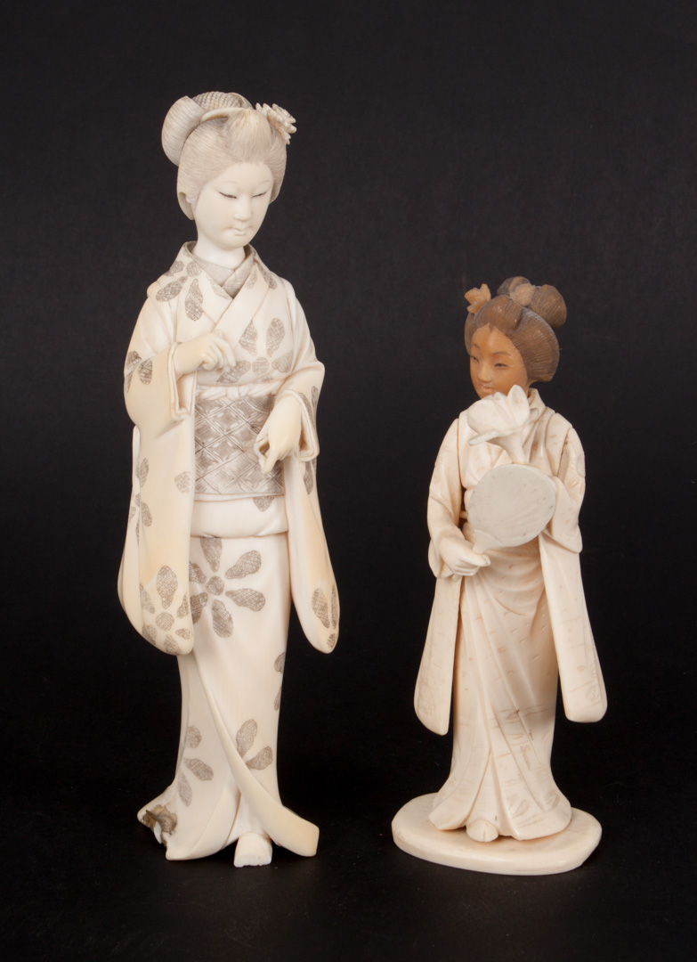 Appraisal: Two Japanese carved ivory geisha figures with ink highlights smaller