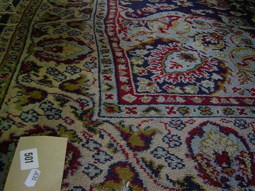 Appraisal: A blue ground wool rug with Persian style floral decoration