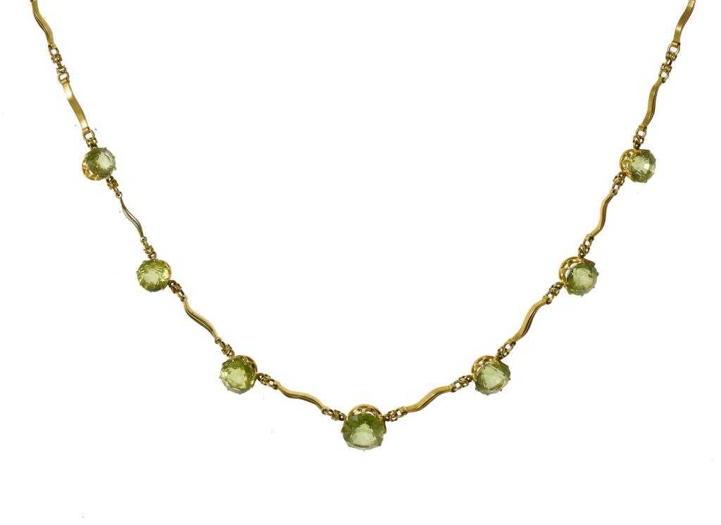 Appraisal: A PERIDOT NECKLACE of seven oval or round well matched