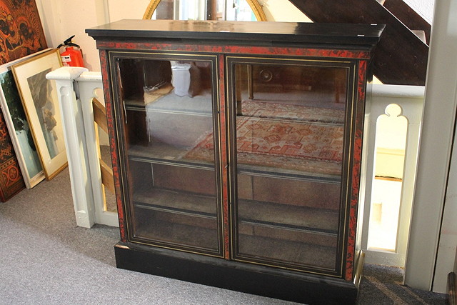 Appraisal: A TH CENTURY EBONISED AND TORTOISESHELL BOOKCASE with plain glazed