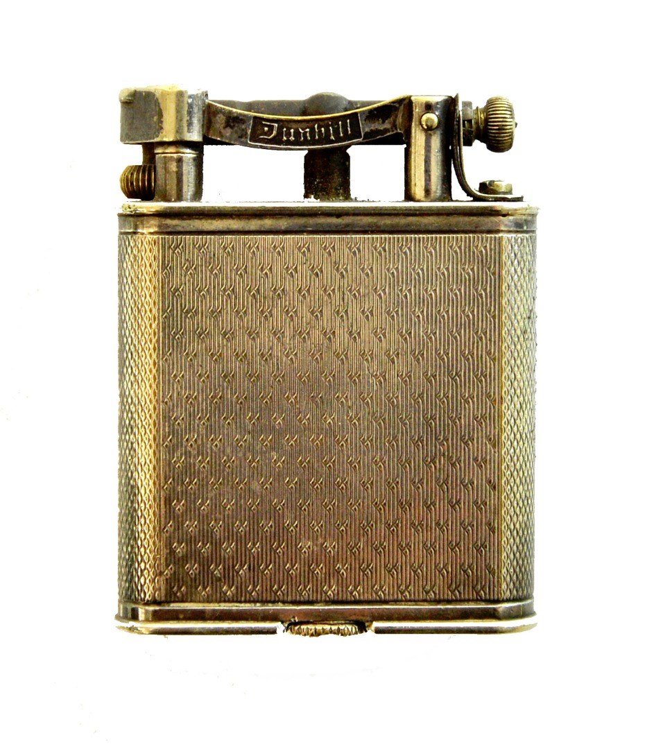 Appraisal: A silver plated Dunhill petrol lighter of curved rectangular form