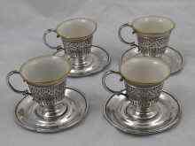 Appraisal: A set of four china tea cups with American silver