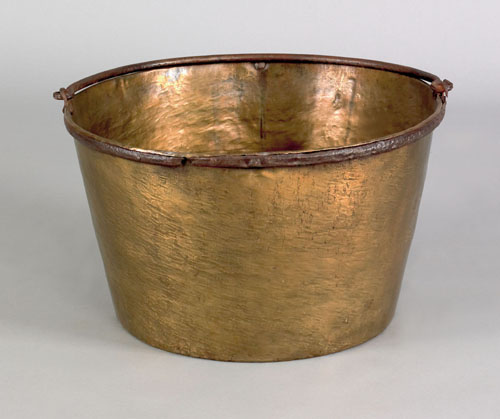 Appraisal: Pennsylvania brass bucket with wrought iron swing handle ca h