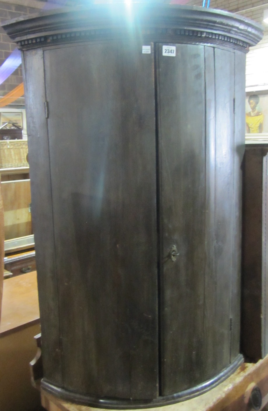 Appraisal: An th century oak bowfront hanging corner cupboard