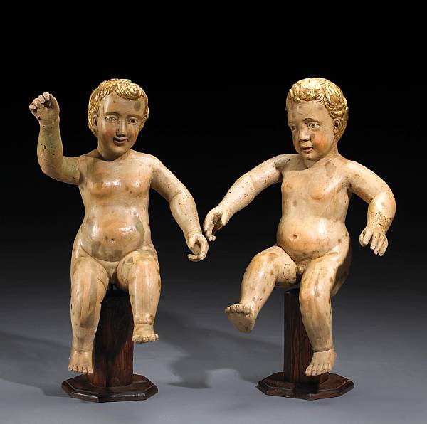 Appraisal: A pair of Italian painted and parcel gilt putti late