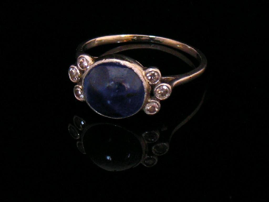 Appraisal: A SAPPHIRE AND DIAMOND DRESS RING the central oval cabochon