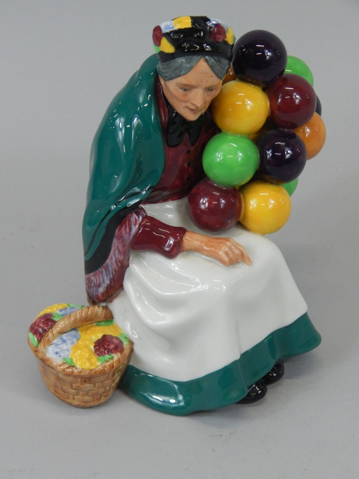 Appraisal: A Royal Doulton porcelain figurine The Old Balloon Seller HN