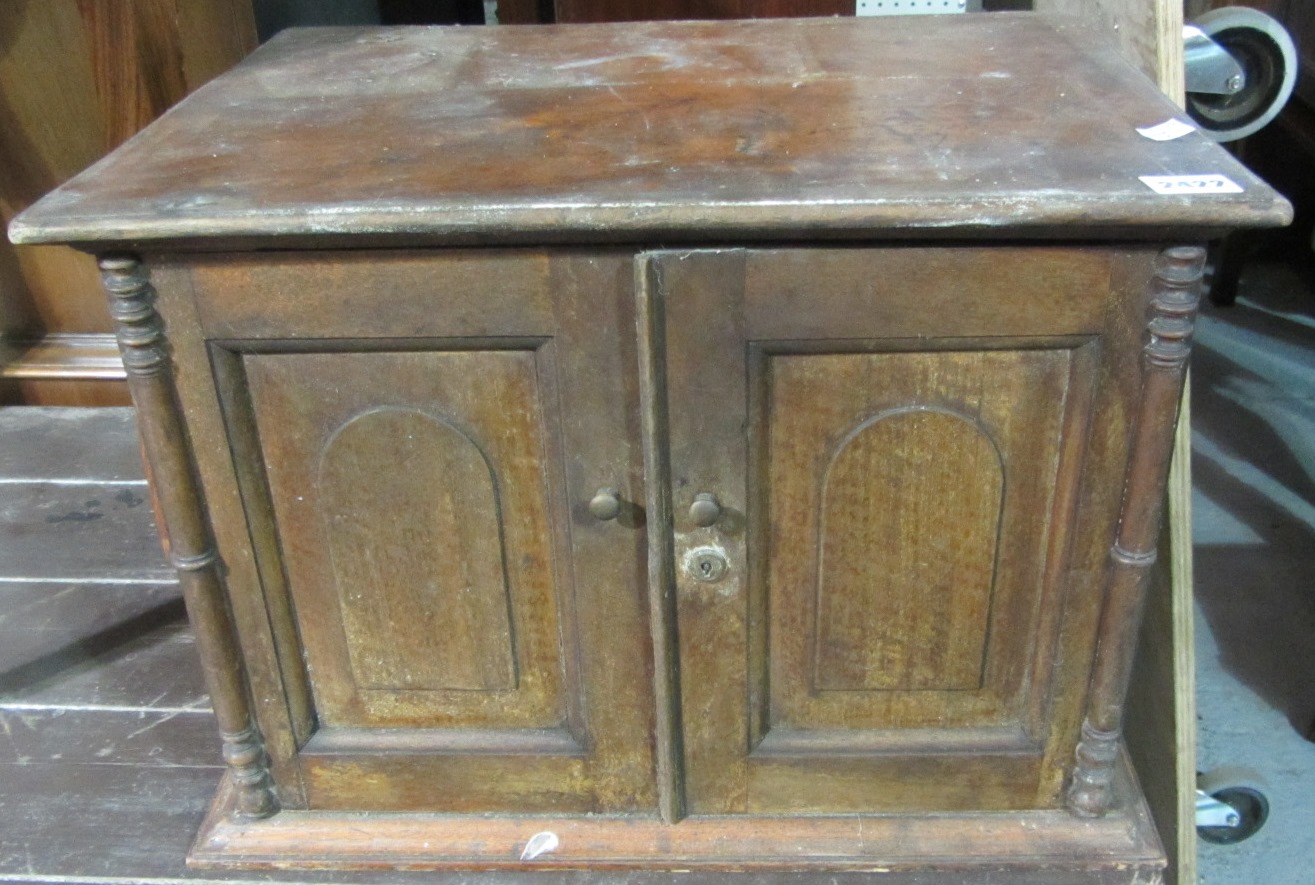 Appraisal: A th century walnut table cabinet with a pair of