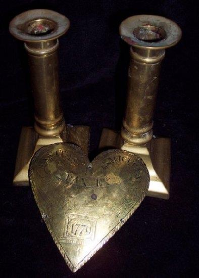 Appraisal: A brass heart shaped plaque engraved 'Sanitas Pax et Amicitia