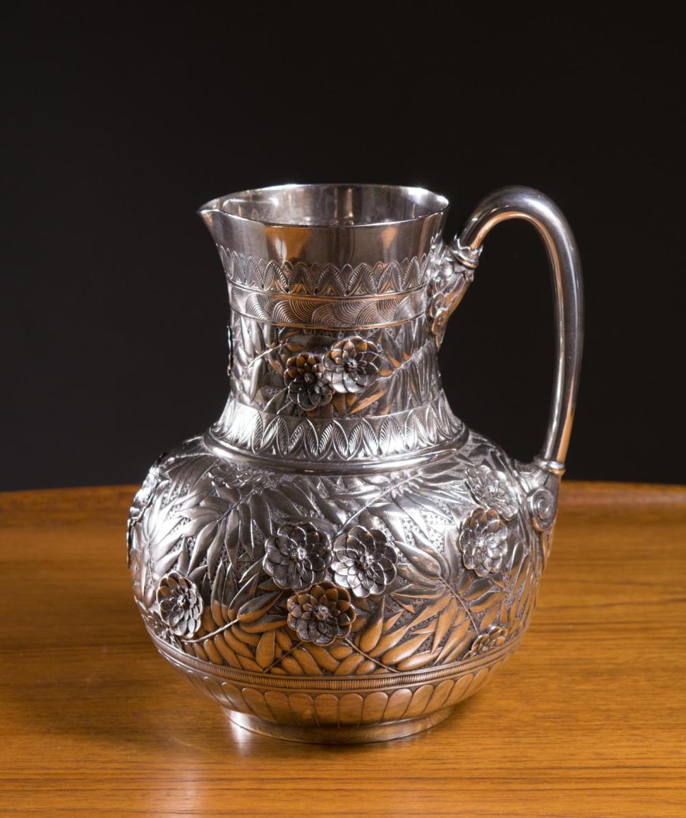 Appraisal: REPOUSSE STERLING SILVER WATER PITCHER featuring a flowers in high