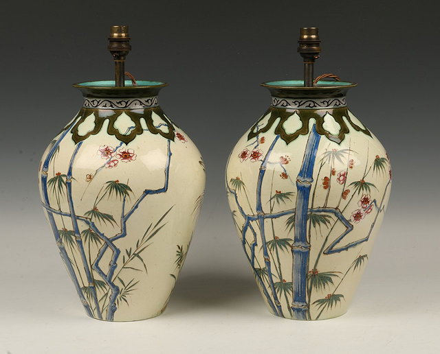 Appraisal: A PAIR OF FRENCH PAINTED POTTERY BALUSTER LAMPS with oriental