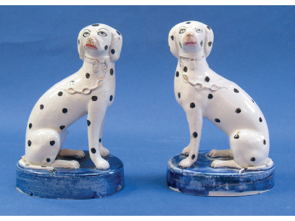 Appraisal: A PAIR OF TH CENTURY STAFORDSHIRE MODELS OF SEATED DALMATIANS