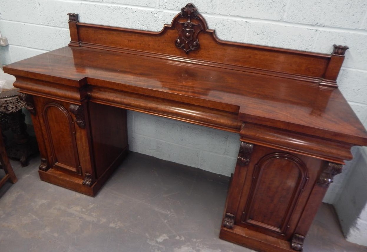 Appraisal: A Victorian mahogany figured pedestal sideboard the raised back decorated