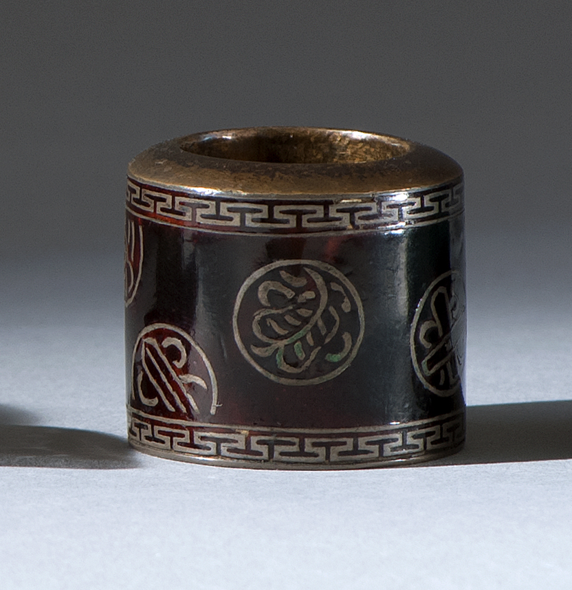 Appraisal: ENAMELED-METAL THUMB RING th CenturyWith rondel design depicting Buddhistic symbols